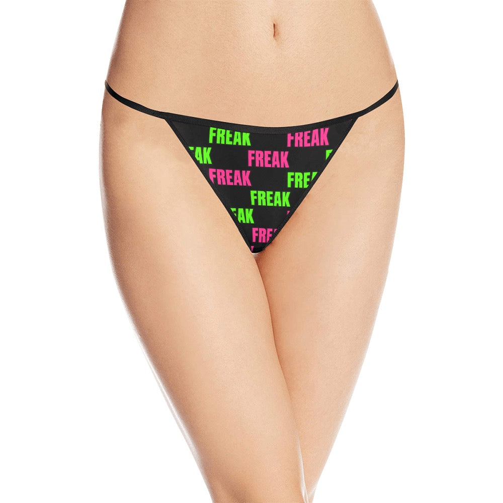 Model wearing black Freak thong with alternating pink and green lettering, front view