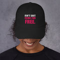 Model wearing black Ain't Shit Come for Free embroidered cap, front view