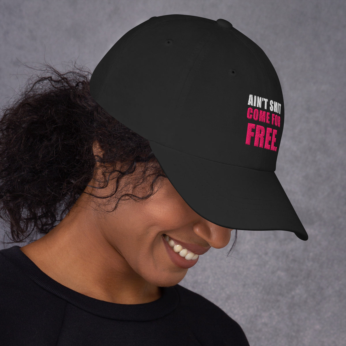 Model wearing black Ain't Shit Come for Free embroidered cap, right-side view