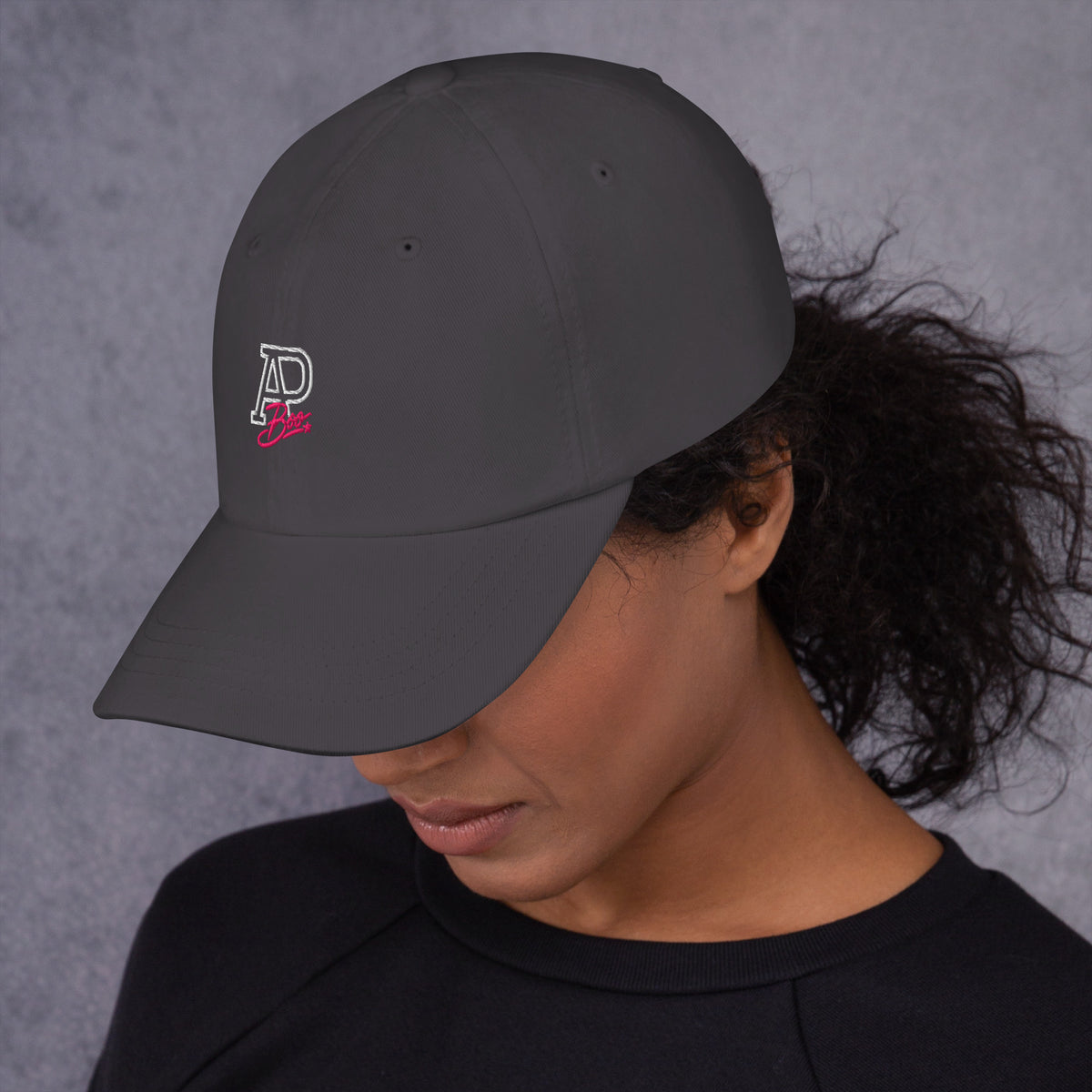 Model wearing dark gray APBoo embroidered cap, left-side view