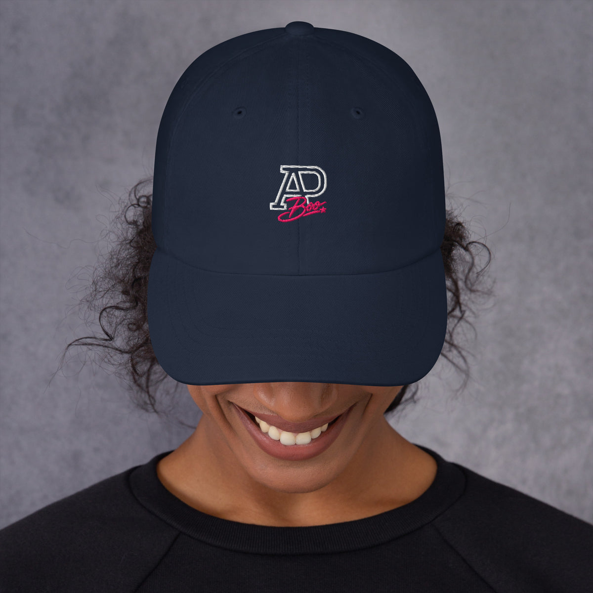 Model wearing navy APBoo embroidered cap, front view