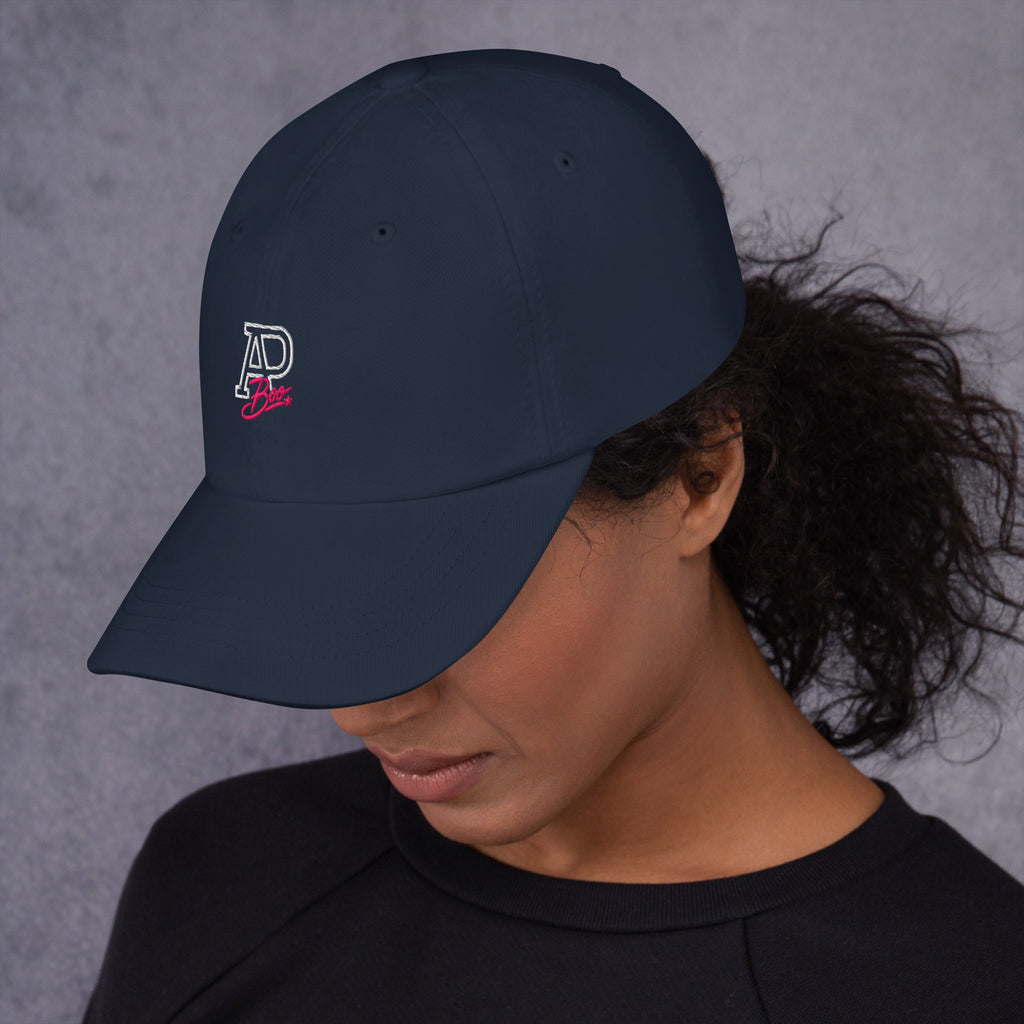 Model wearing navy APBoo embroidered cap, left-side view